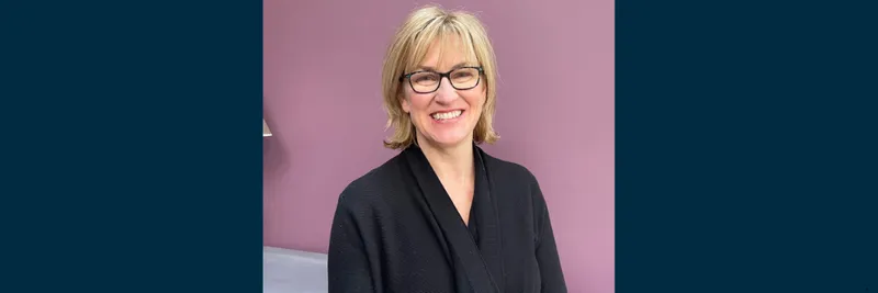 Professor Clare McGlynn smiling to camera, against a light purple background