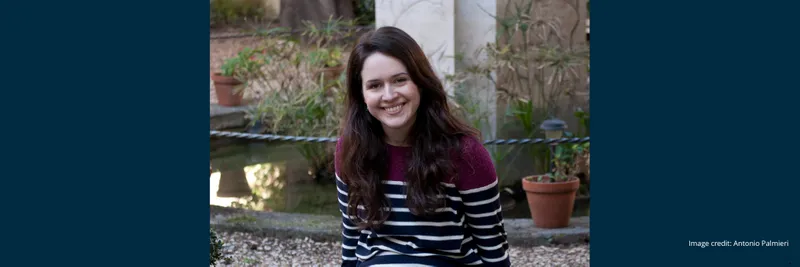 Dr Katherine McDonald smiling and facing the camera whilst sat in an outdoor setting