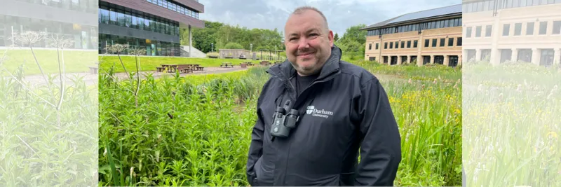 New Biodiversity Manager Ian Armstrong smiling in front of a pond