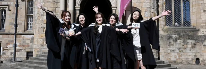 Group of 5 students in front of University College steps