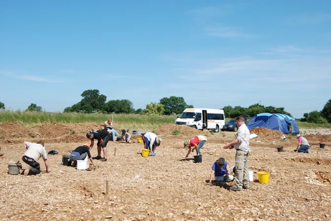 Group of students looking for artefacts, with a minibus in background
