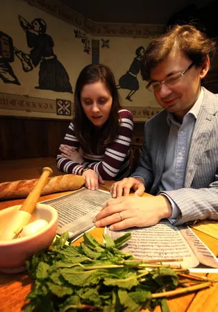 People look at medieval recipes with food on the table