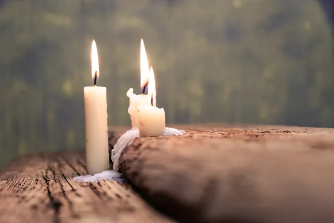 Candles burning on an old oak table