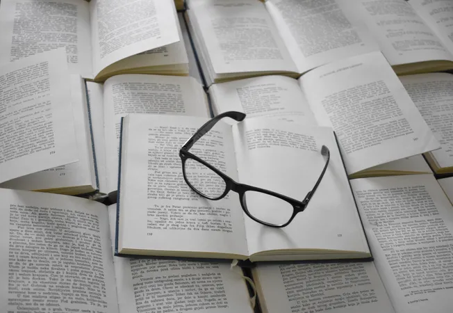 Glasses on a pile of open books