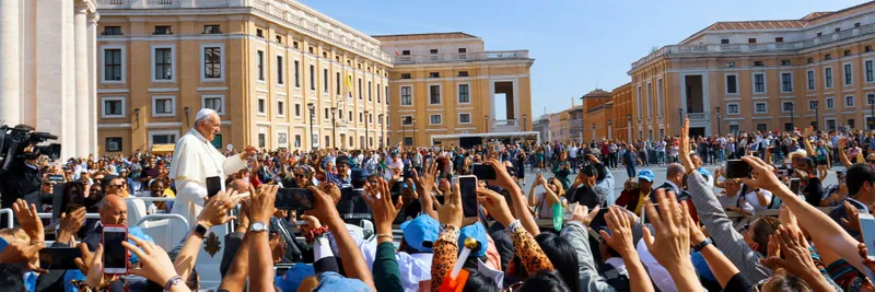 Pope Francis greeting crowds of people