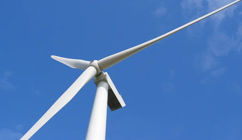 A wind turbine against a clear blue sky