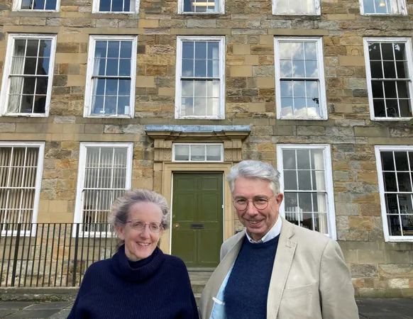 Paul Murray and Karen Kilby outside the exterior of Abbey House 2023