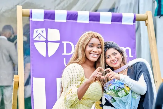 Two students creating a heart shape with hands