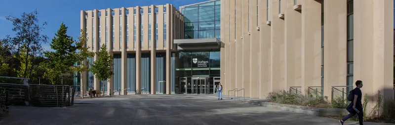 Entrance of Waterside building on a sunny day with a couple of people walking outside
