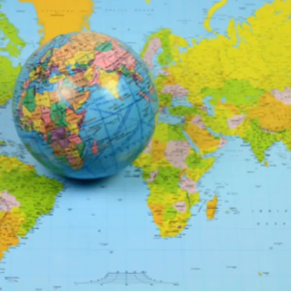 A small globe resting on a world map