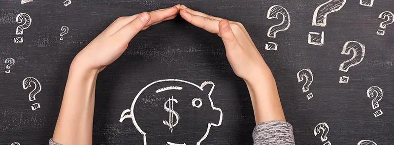 Hands on a chalkboard surrounding piggy bank drawing