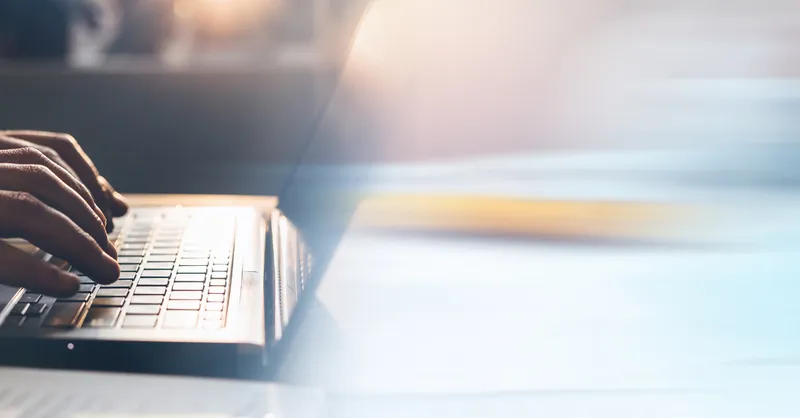 someone typing on a laptop