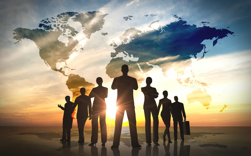 Silhouette of people in front of world map