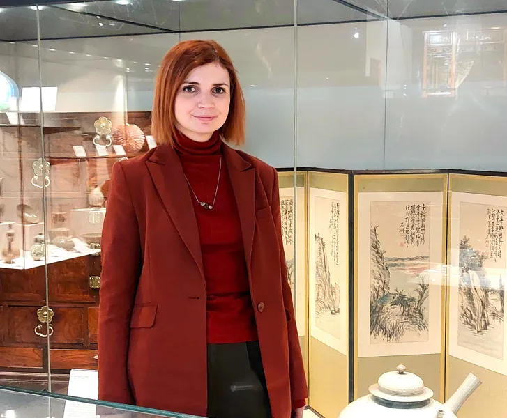 A woman standing in front of a museum display