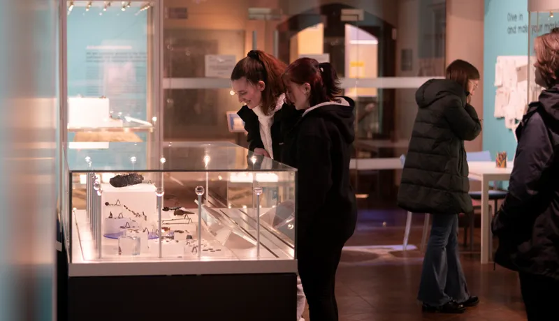 Image of two students looking into a museum case