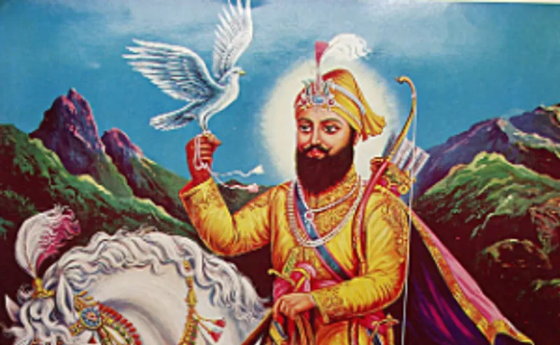 Modern print of Guru Gobind Singh, the tenth guru of Sikhism. He is depicted mounted on a white horse, wearing yellow or gold clothes and a turban, and is wearing necklaces and a turban ornament made of gemstones and pearls.