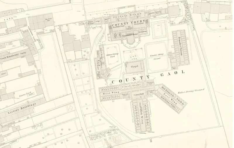 Zoomed-in image of a 19th-century map showing Durham Jail, made up of newly built structures with large exercise yards between them. Other buildings of the City of Durham can be seen outside the prison walls.