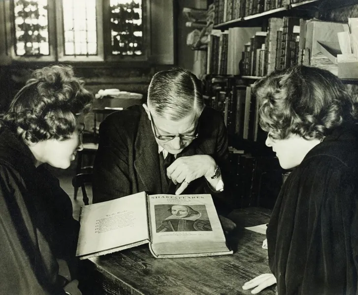 Three people study a copy of Shakespeare’s first folio at Palace Green Library.