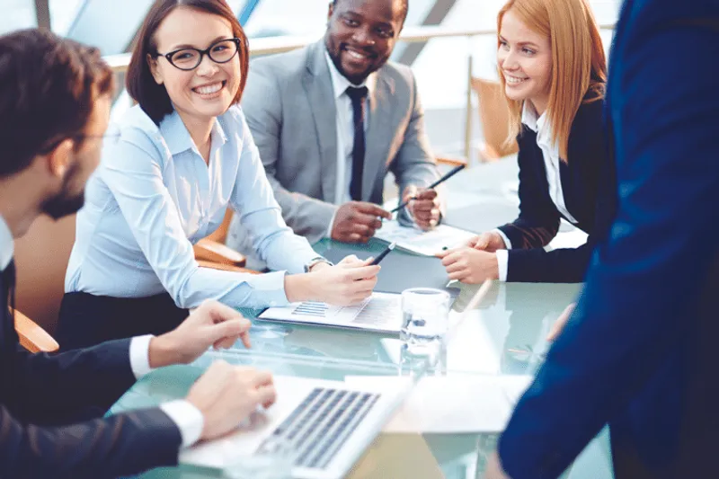 Group of business people looking at a notice board