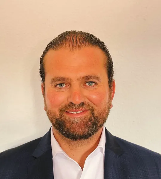 A headshot of Isber Sabrine