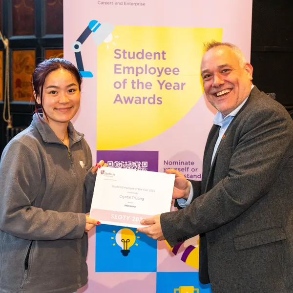 Crystal Truong collecting the Intern of the Year On Campus Award at the Student Employee of the Year Awards 2024