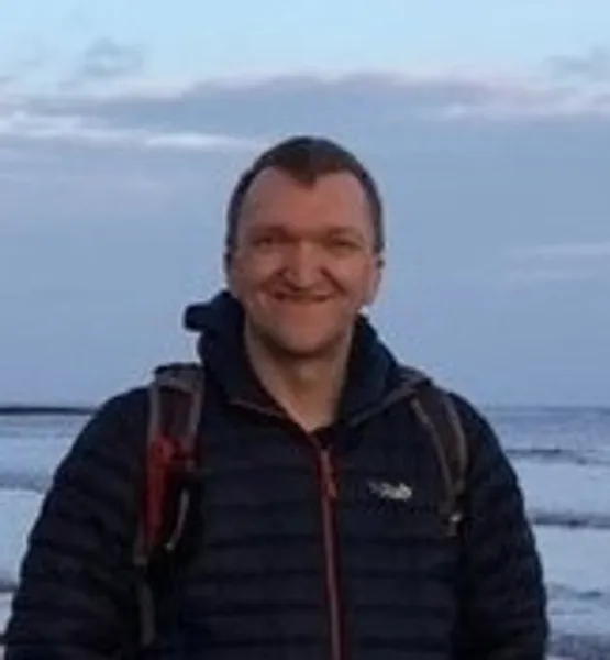 A headshot of Paul Hughes