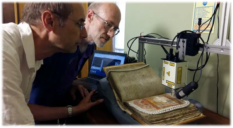 Professor Richard Gameson and Professor Andrew Beeby looking at medieval books
