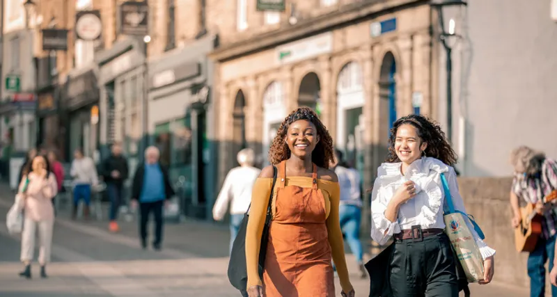 Two students walking in Durham City Centre