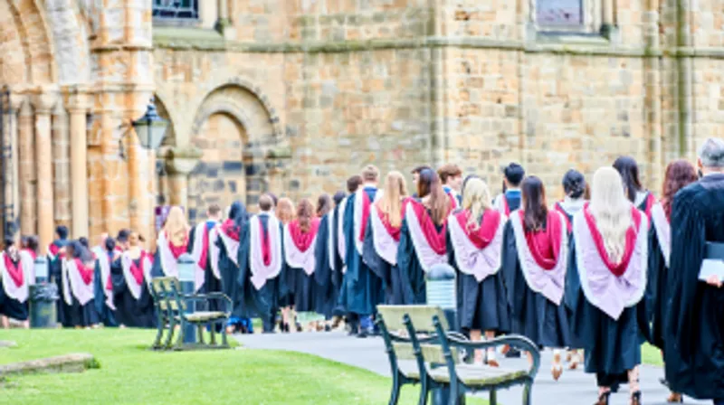 students in robes walking into the Cathedral during congregation