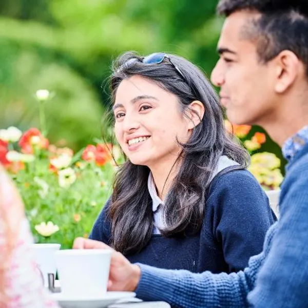Students enjoying the Botanic Garden at cafe benches