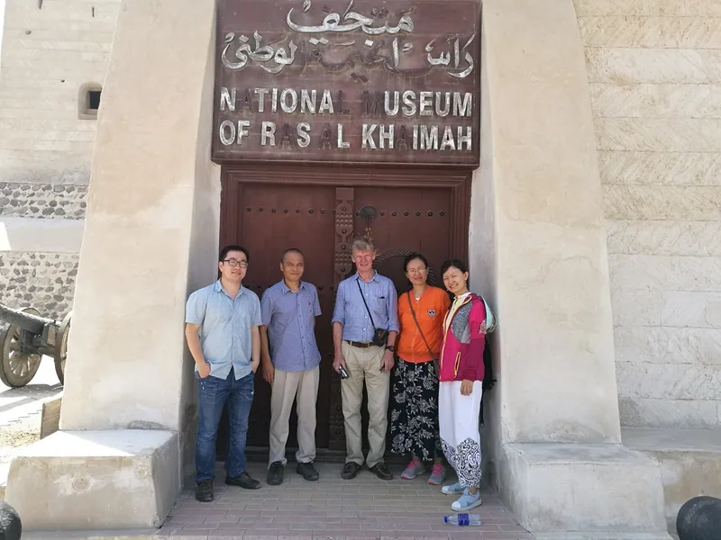 A group of archaeologists standing in front of a museum