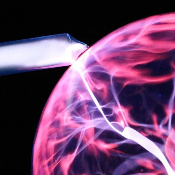 Helium gas glowing when in contact with a plasma ball