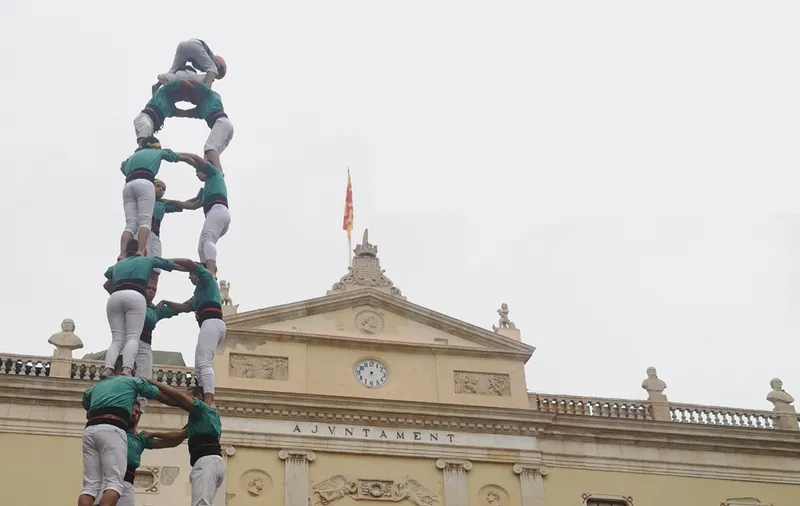 A human tower or castell built traditionally at festivals in Catalonia, the Balearic islands and the Valencian Community