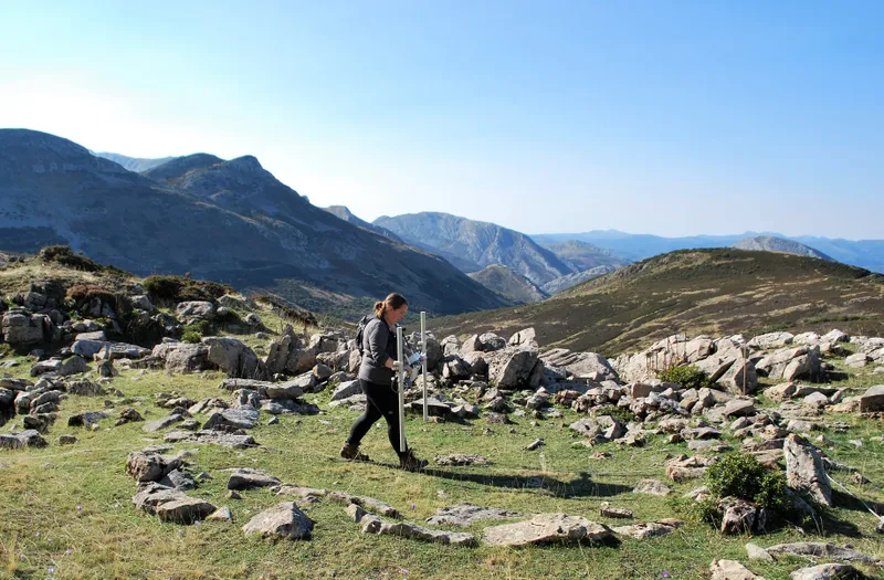 Person walking with two sticks and the Cantabrian Mountains in the background