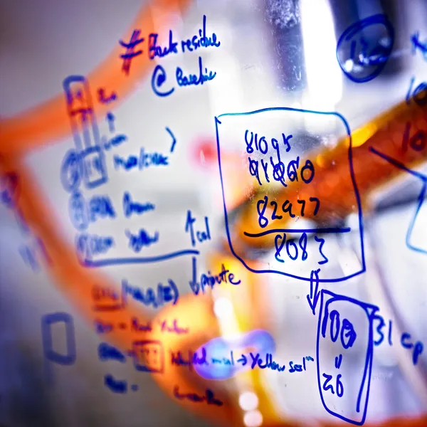 Chemistry equations written on a clear screen