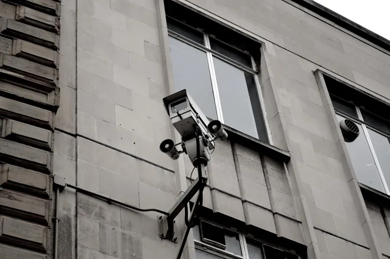 A CCTV camera outside a grey building