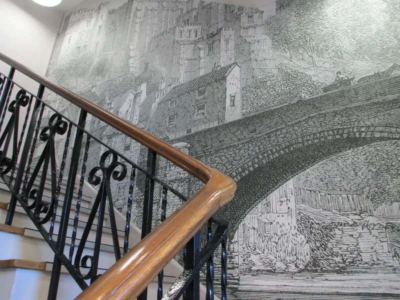 Wall mural behind a staircase in the Department of History