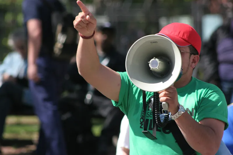 A protestor speaks into a megaphone