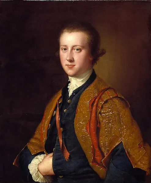 A young man stands in formal wear