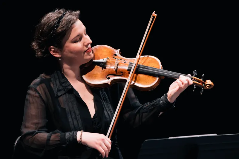 A woman playing the violin