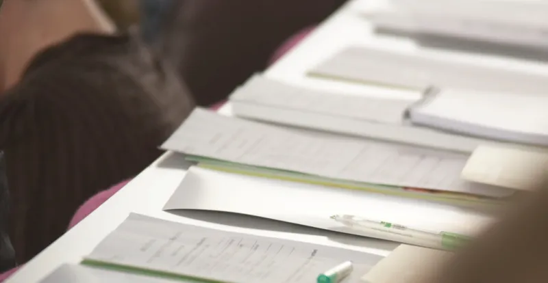 Sheets of handwritten notes laid out side by side on a table