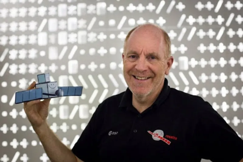 Image of Prof Mark McCaughrean holding a model of the Rosetta probe