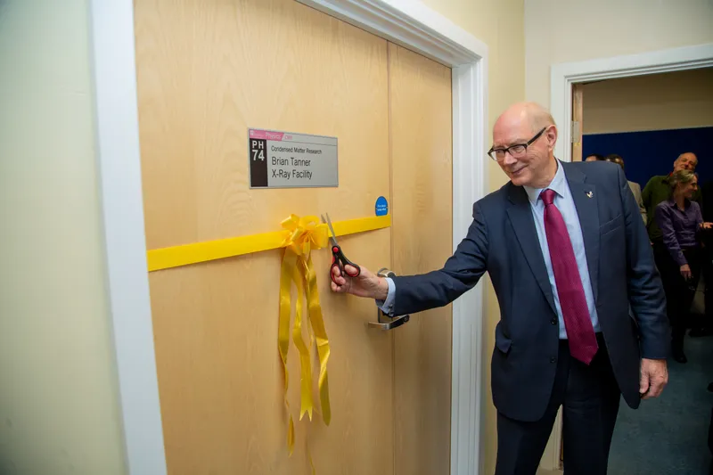 Prof Tanner cuts the ribbon