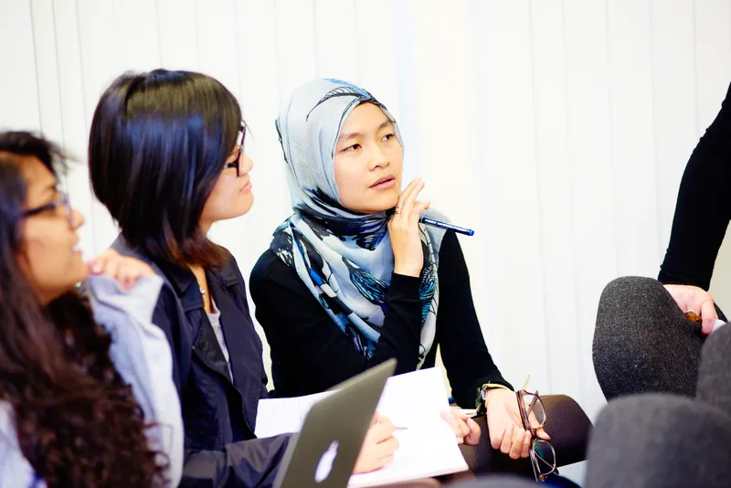 Postgraduate students discussing their work in a Psychology seminar