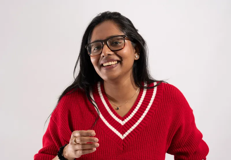 A girl smiling in a red jumper