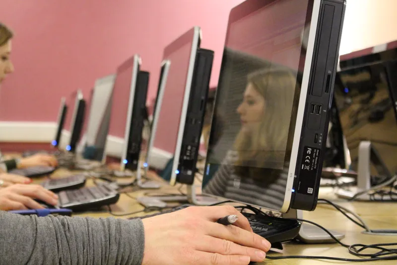 Image of a student sat at a computer