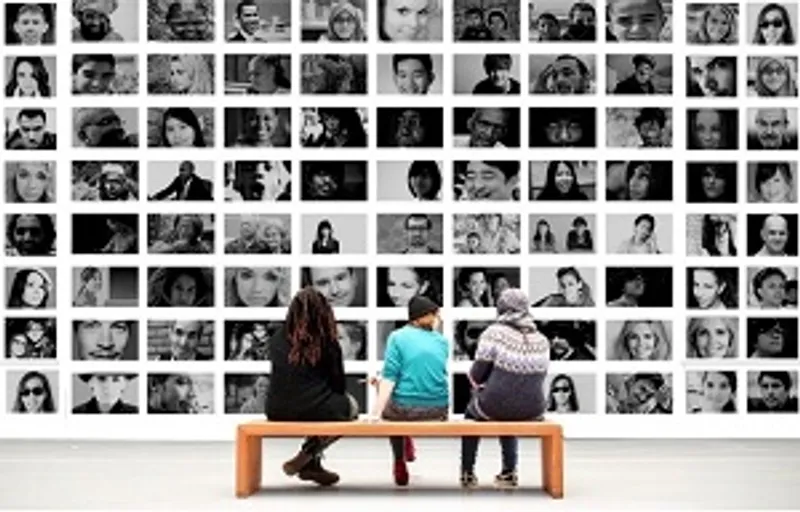 Students sitting in front of black and white portrait images