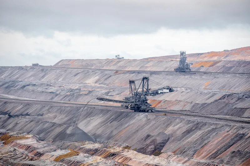 A mechanical digger on a carbon landscape