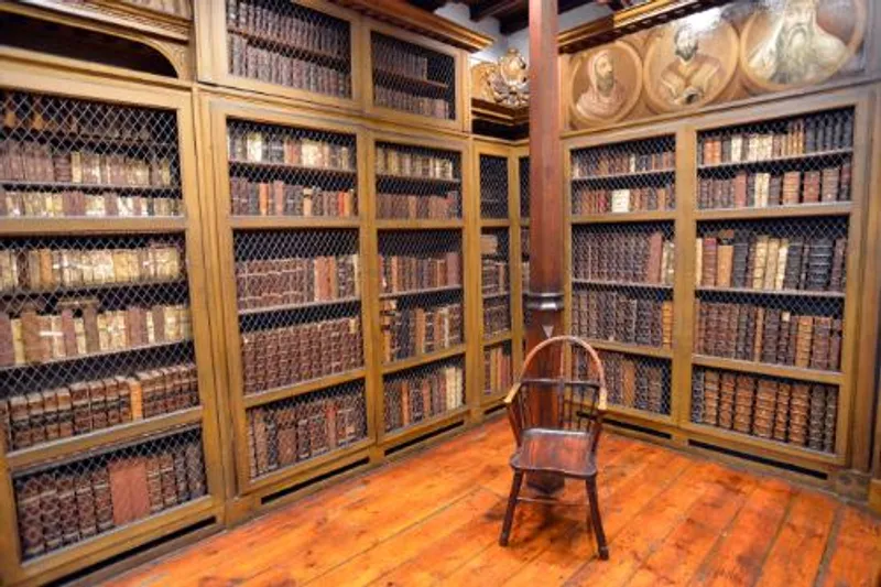 Books on bookcases in Cosin’s Library with a chair in front of a pillar