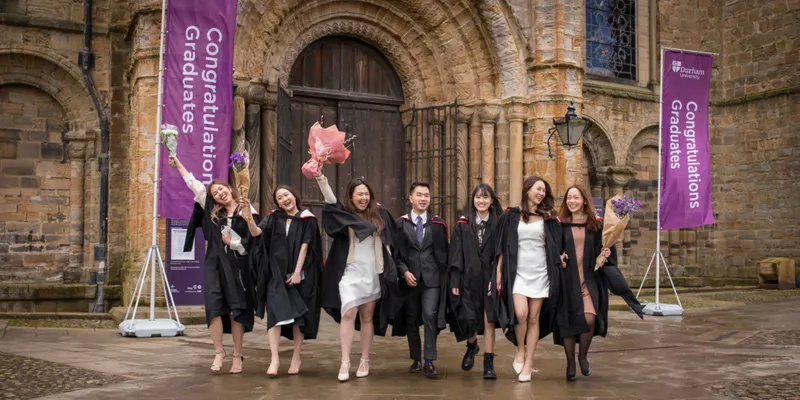 Graduates celebrating outside Durham Cathedral